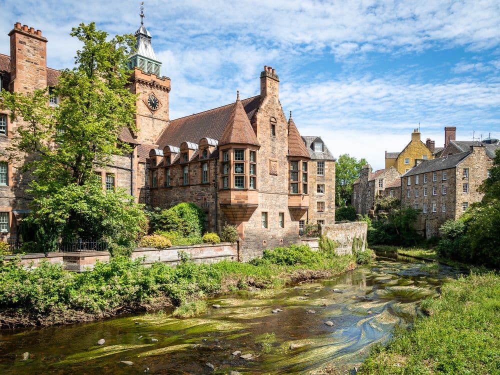 The historic Well Court building with its iconic red stone in Dean Village, Edinburgh, Scotland.
