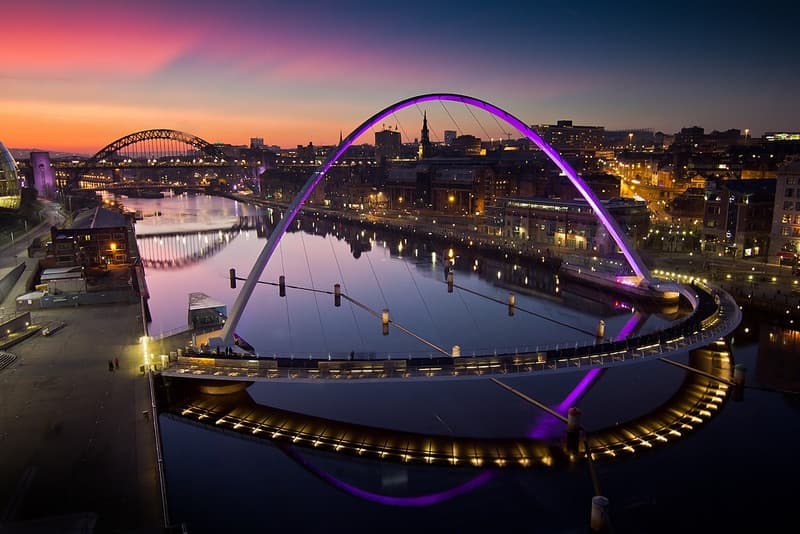 The Quayside at sunset with the Millennium Bridge illuminated. Newcastle, England.