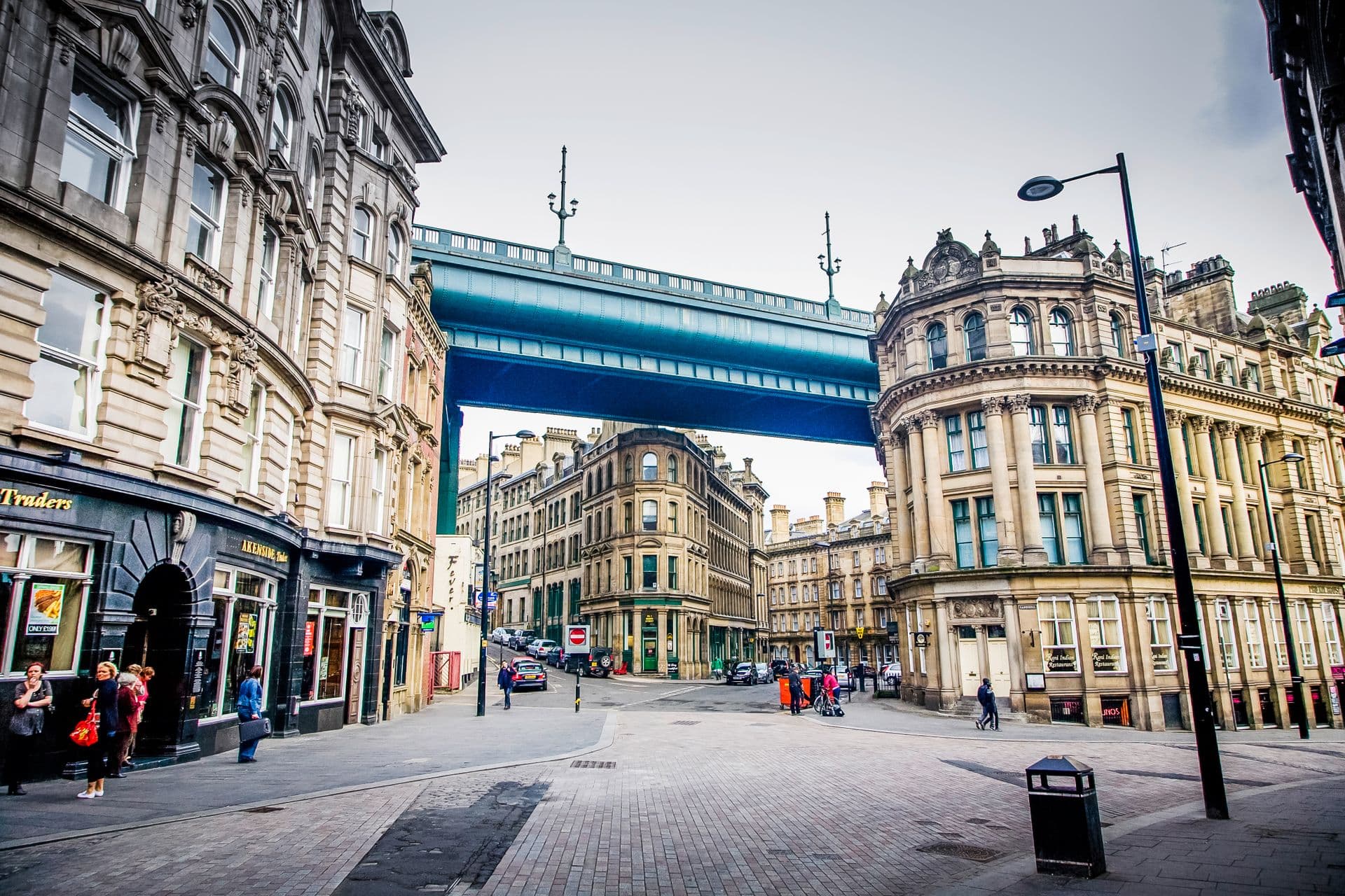 Buildings tucked under the majestic Tyne Bridge in Newcastle, England.