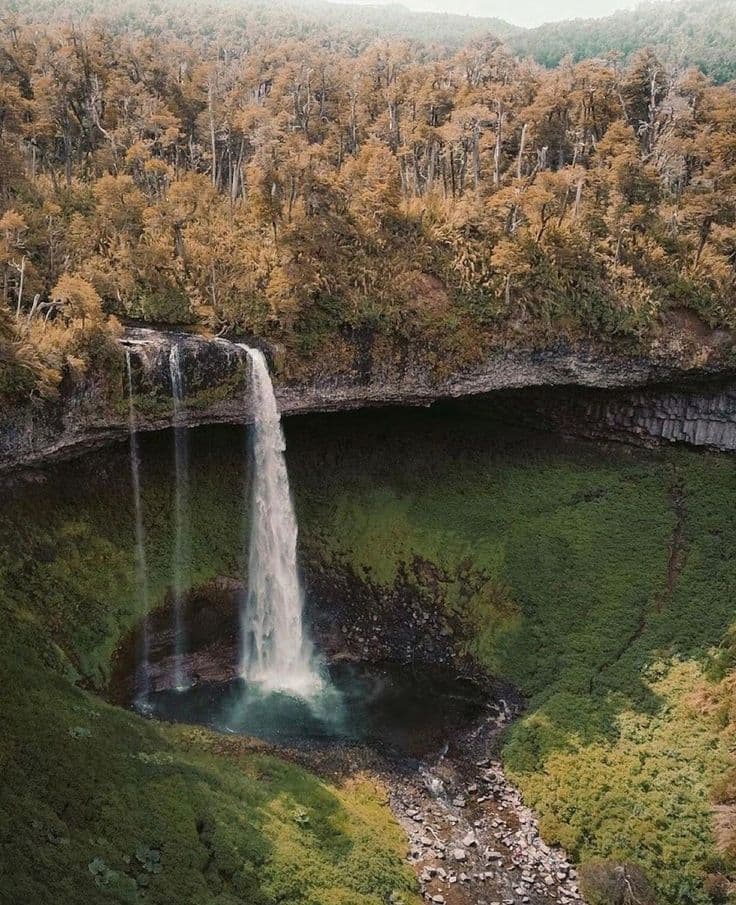 Powerful water drop of the Santa Ana Waterfall framed by a massive volcanic rock cave.