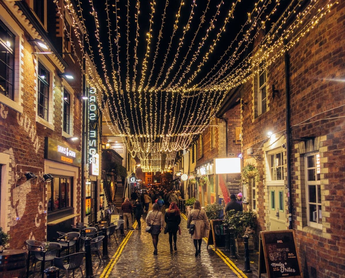 The picturesque cobbled alleyway of Ashton Lane illuminated by fairy lights at night in the West End of Glasgow.