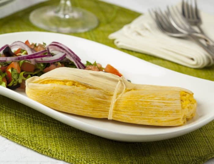 Humitas. A corn-based dough cooked in its own husk, sometimes filled with cheese or other ingredients.