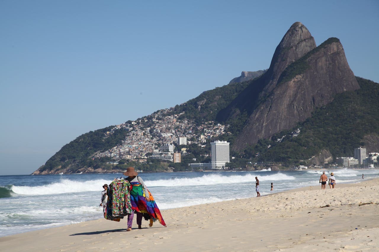Iconic Ipanema beach. In the background Morro Dois Irmãos and the Vidigal community in Rio de Janeiro, Brazil.