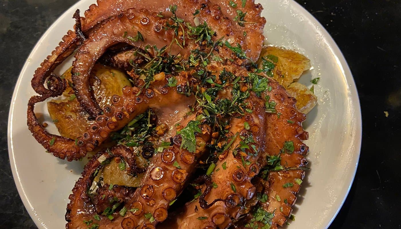 In Ilha Grande, Brazil, the cuisine is based on fresh seafood such as shrimp and octopus, with moqueca and caldeirada as signature dishes.