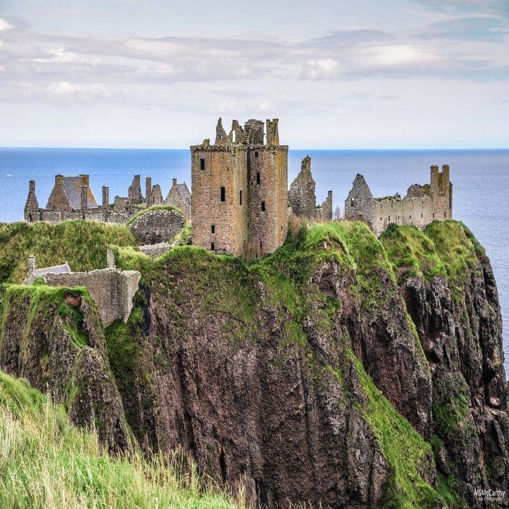 The ruins of Dunnottar Castle on an imposing cliff surrounded by the North Sea in Scotland.