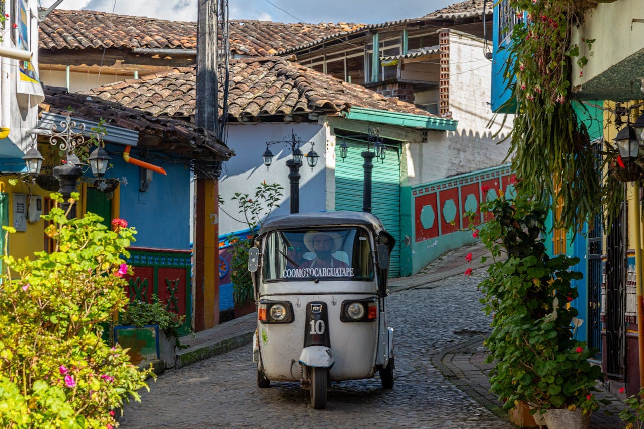 A colorful motochiva in Guatapé, Colombia—a mototaxi decorated with traditional zócalos. Always agree on the price before getting in, though they are usually very budget-friendly (a few dollars for the ride to El Peñol).
