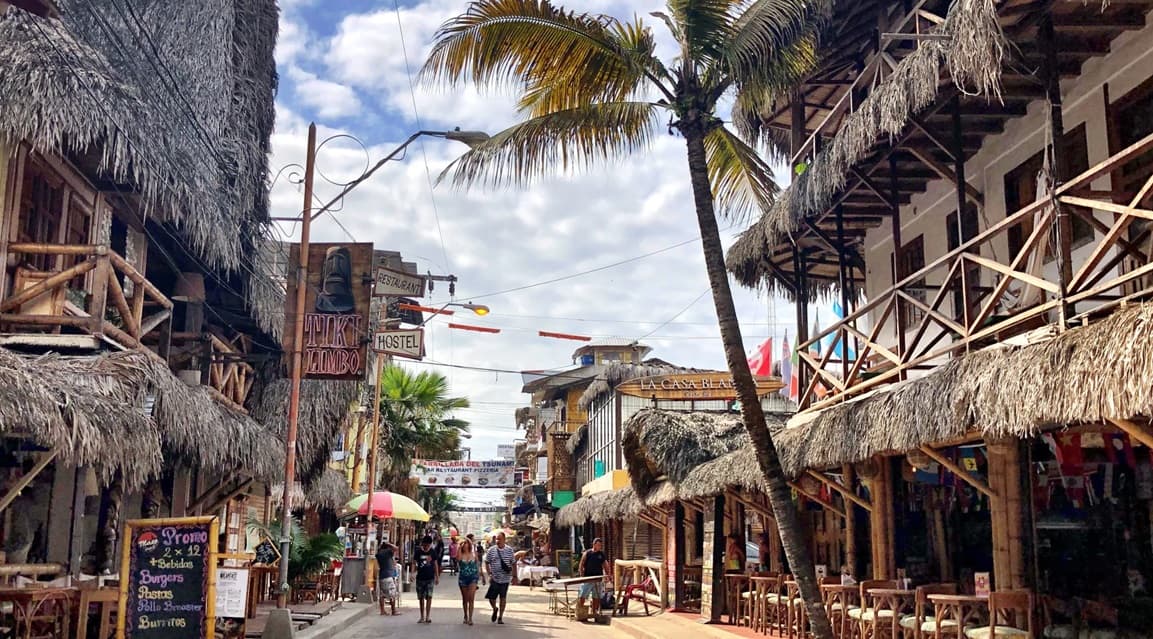 Colorful streets in downtown Montañita, Ecuador, full of shops and bohemian atmosphere.