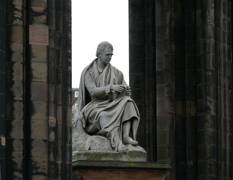 Massive white marble statue of Sir Walter Scott alongside his faithful dog Maida, sculpted by John Steell, at the base of the Scott Monument, Edinburgh, Scotland.