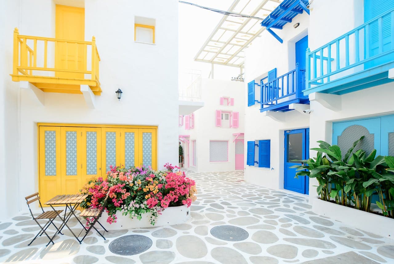 Traditional alleys with white houses and colorful window and door details.
