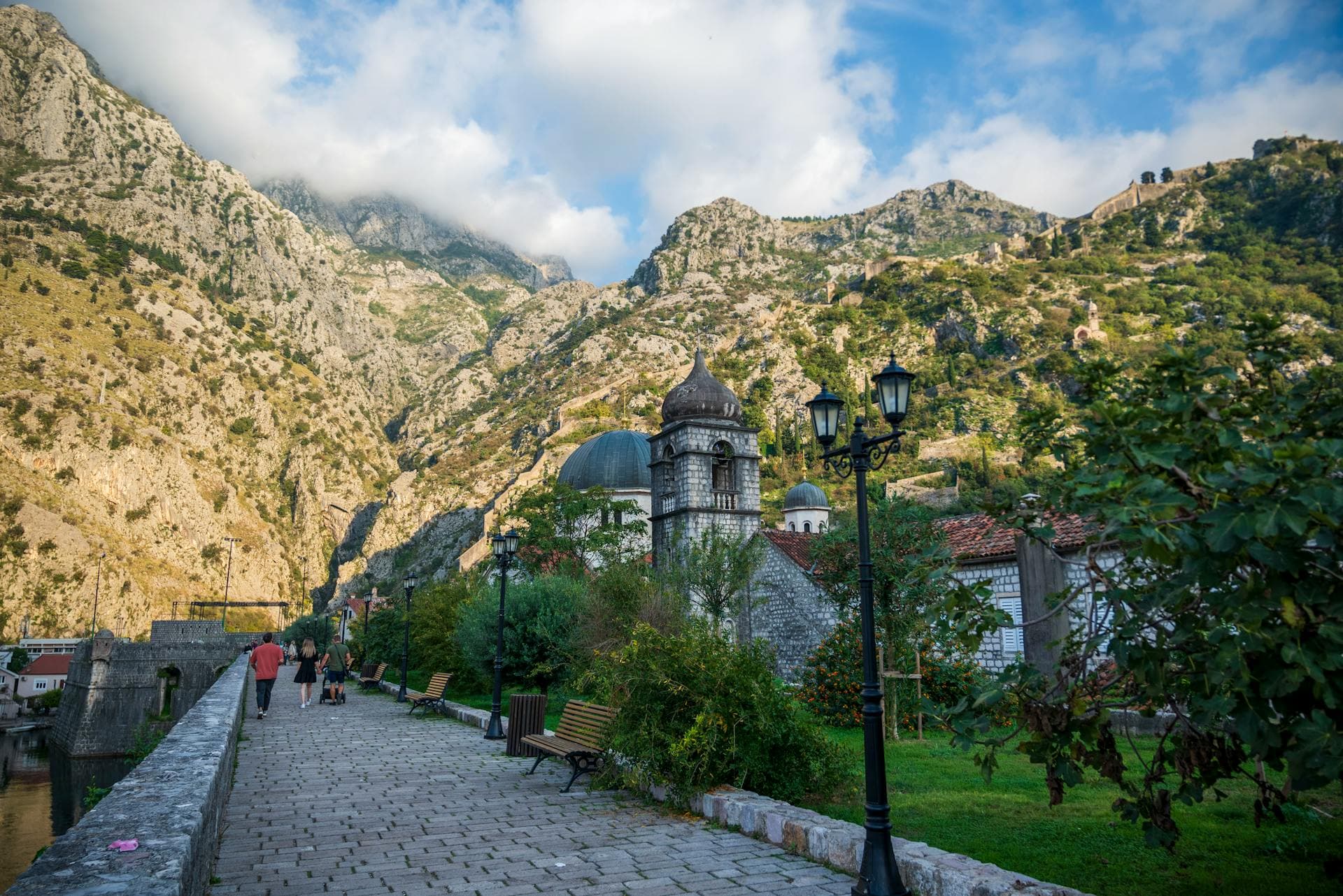 Seaside promenade surrounded by striking mountains in Kotor, Montenegro.