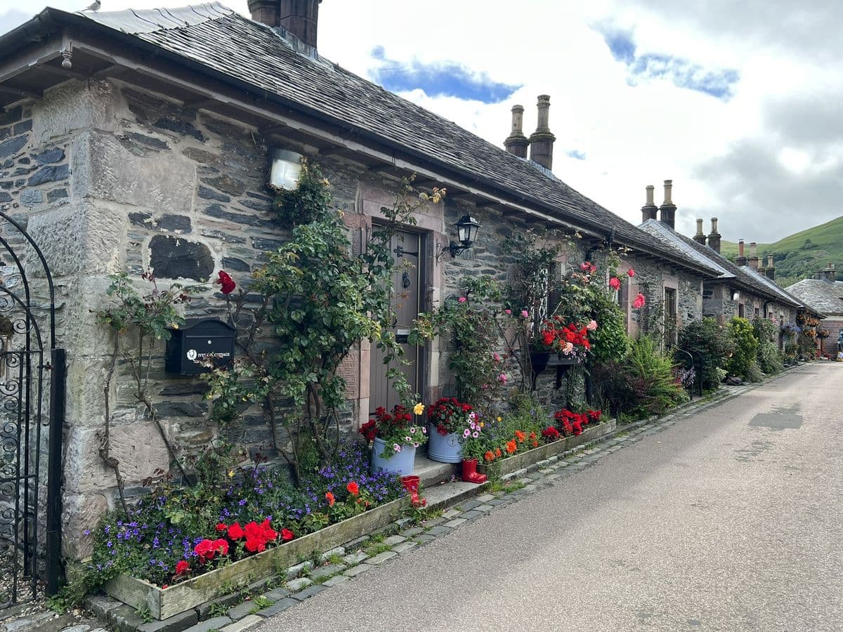 Beautiful stone cottages surrounded by flowers on the streets of Luss village, Loch Lomond.