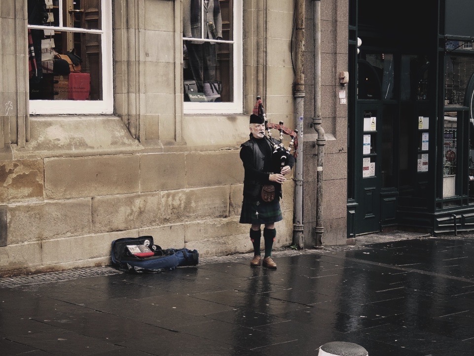 Artista callejero tocando la gaita en las calles de Edimburgo, Escocia.