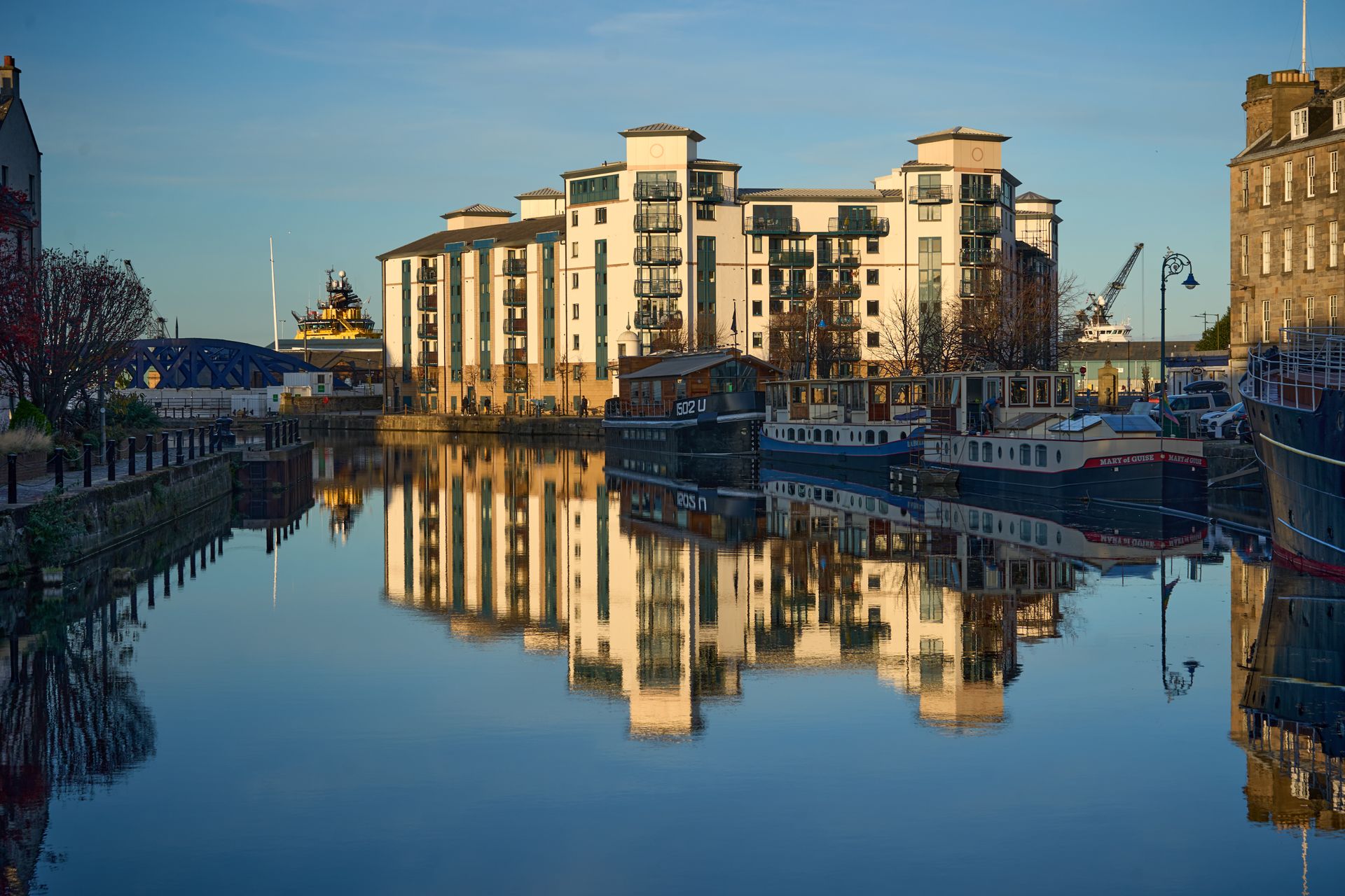 Panoramic view of the Leith canal with reflections and modern buildings at sunset. Edinburgh, Scotland.