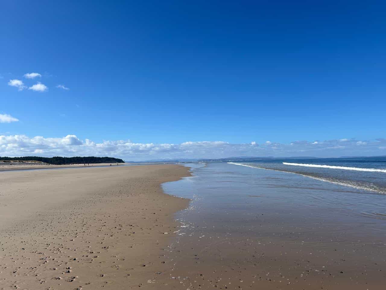 The vast fine sand beach of Findhorn, Scotland, during low tide.