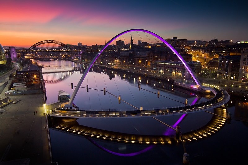 The Quayside at sunset with the Millennium Bridge illuminated. Newcastle, England.