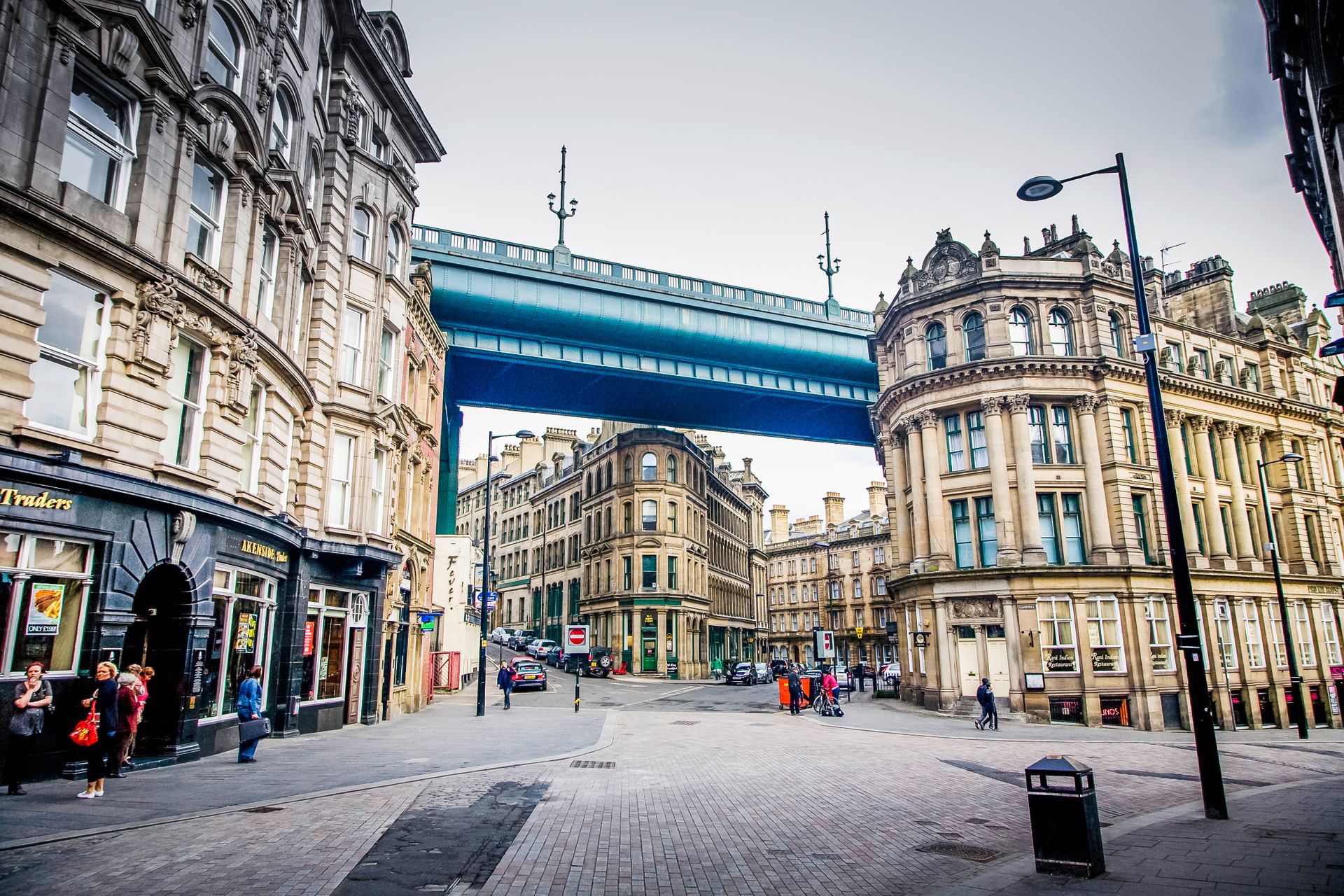 Buildings tucked under the majestic Tyne Bridge in Newcastle, England.