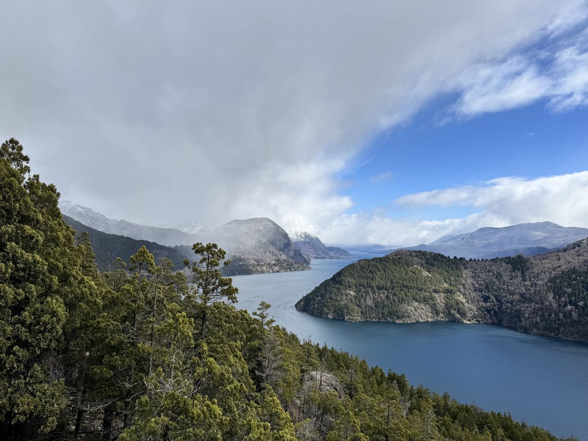 Aerial view of Lake Lácar tucked between steep mountain ranges from the Arrayán viewpoint.